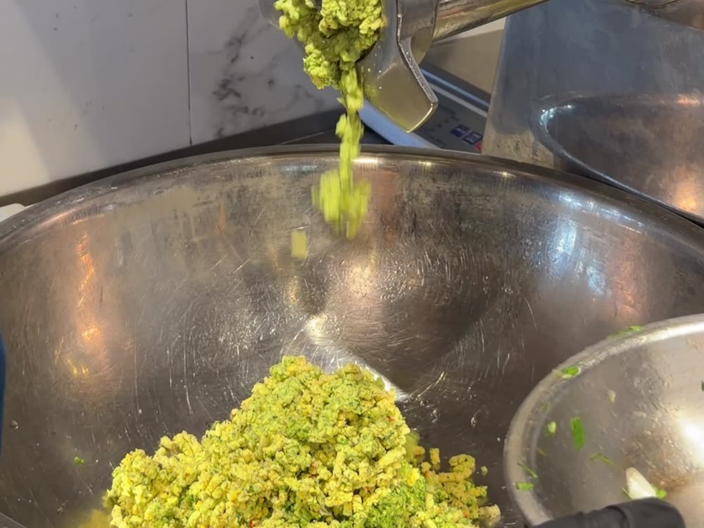 Fresh green falafel mixture ground in the kitchen